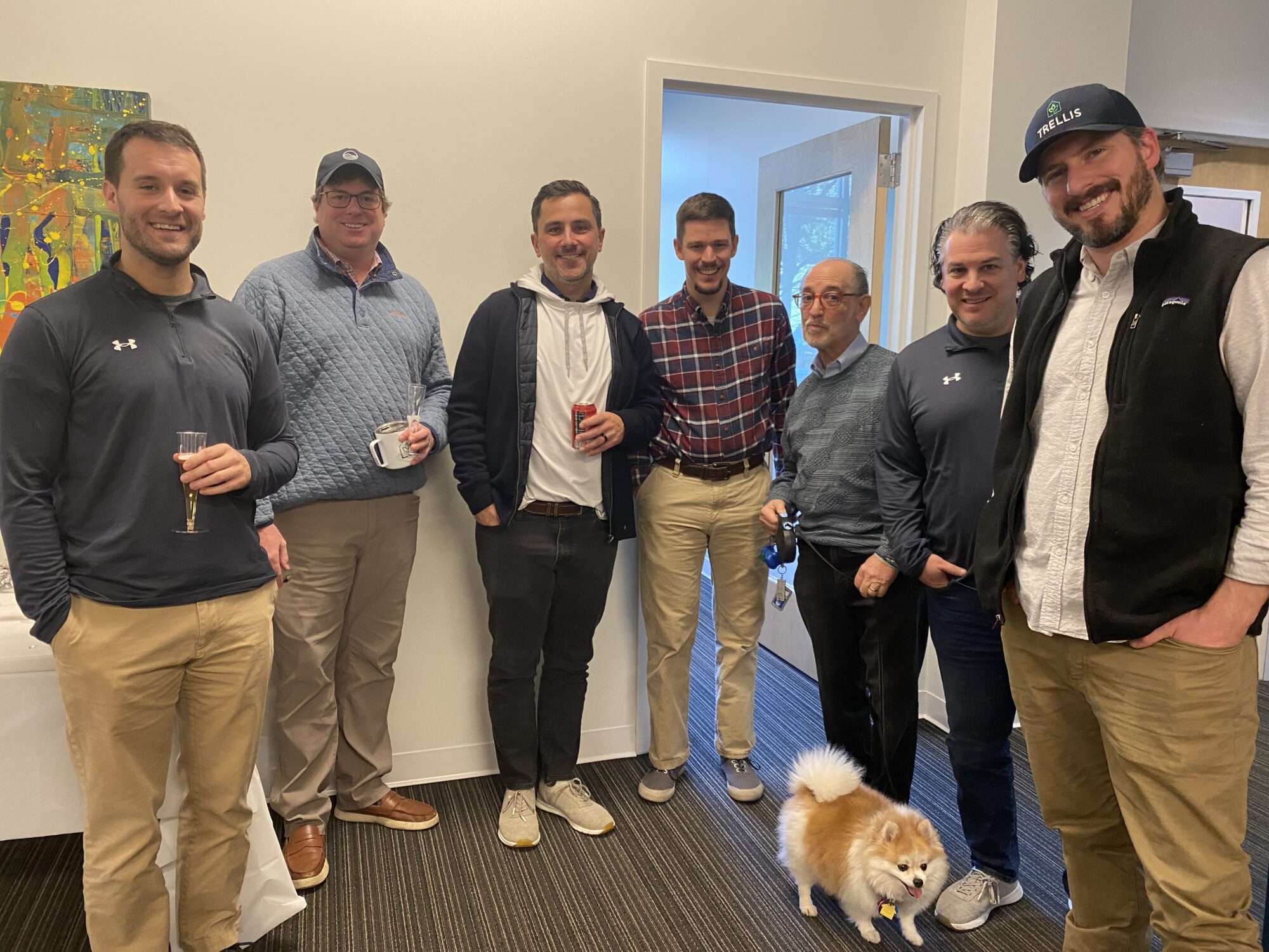 Blue Ocean team grouped with small office dog